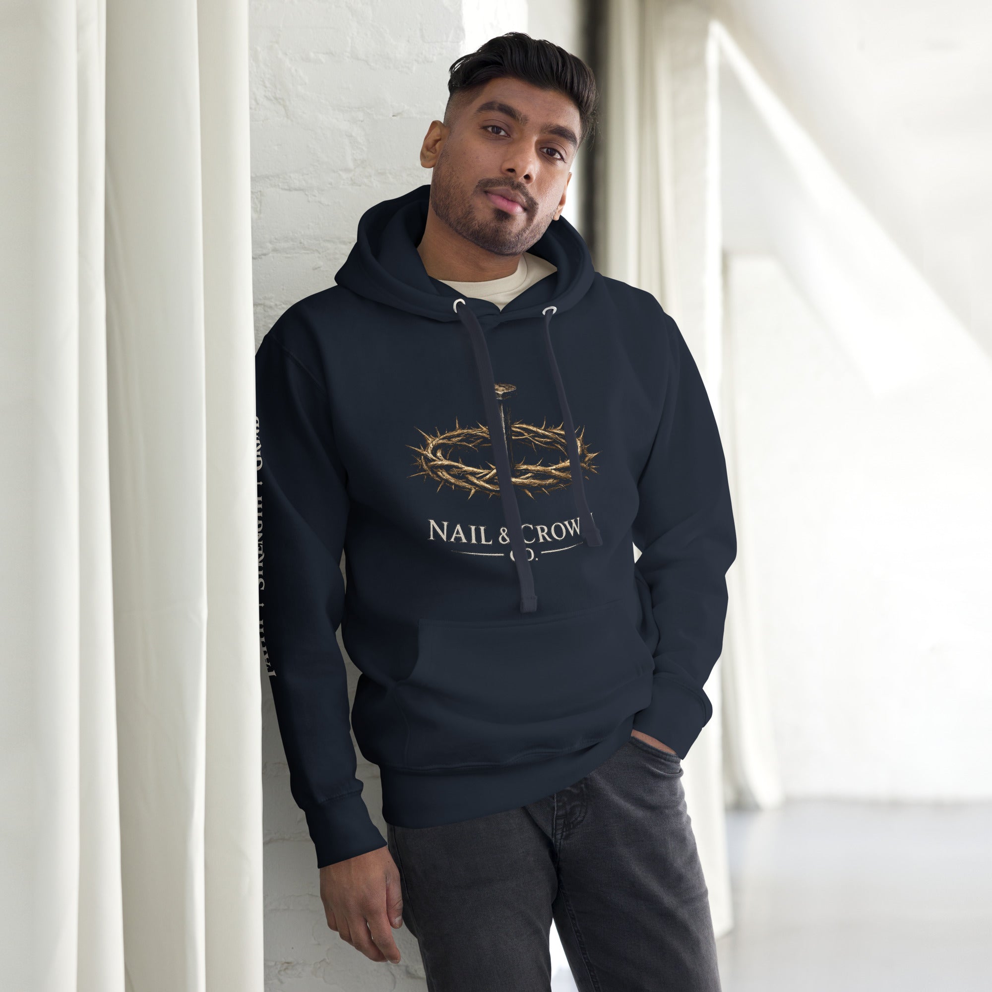 Man wearing Nail & Crown Co. Navy Blazer Unisex Pullover Hoodie — Faith Strength Grind Christian Streetwear