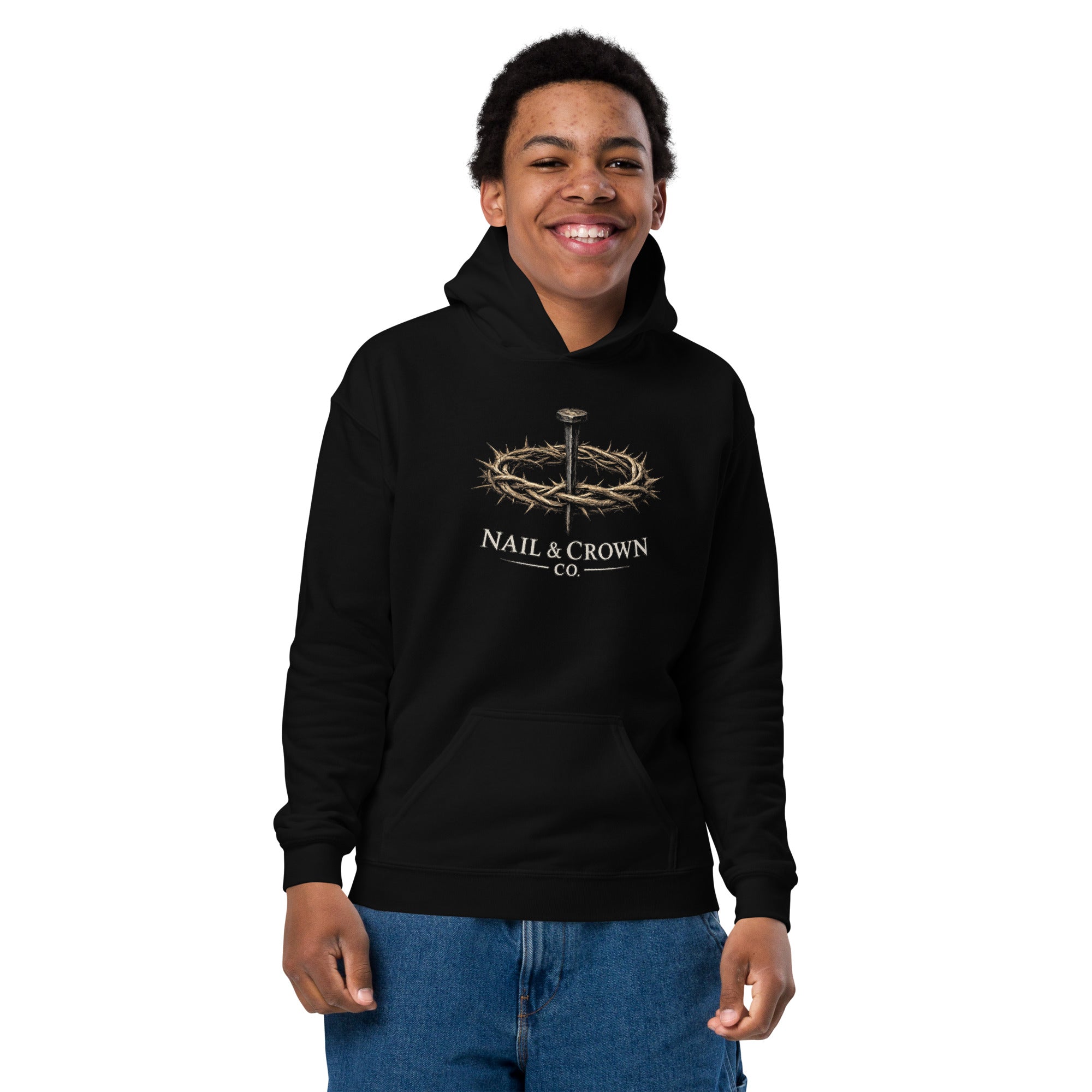 Youth wearing Nail & Crown Co. pullover hoodie in black with nail and crown of thorns logo on chest