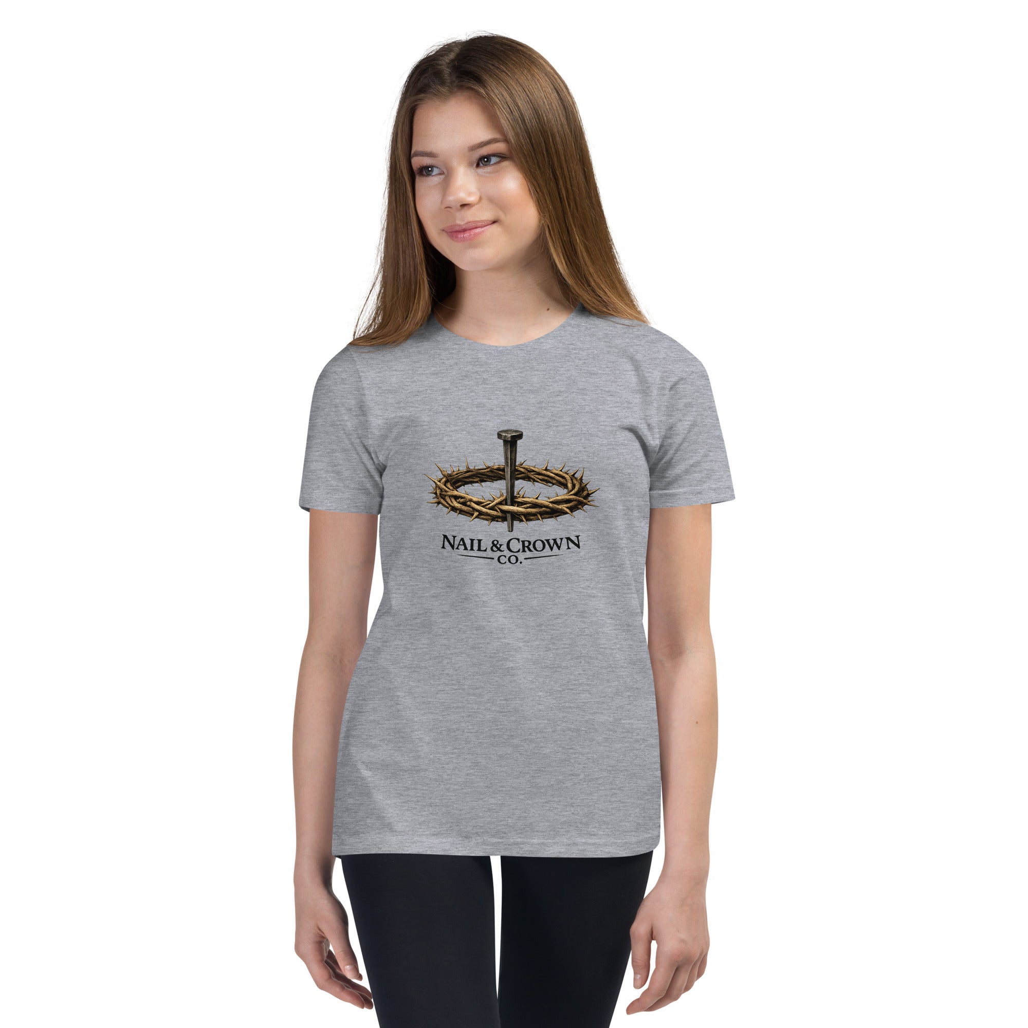 Youth wearing Nail & Crown Co. short sleeve t-shirt in athletic heather grey with nail and crown of thorns logo on chest